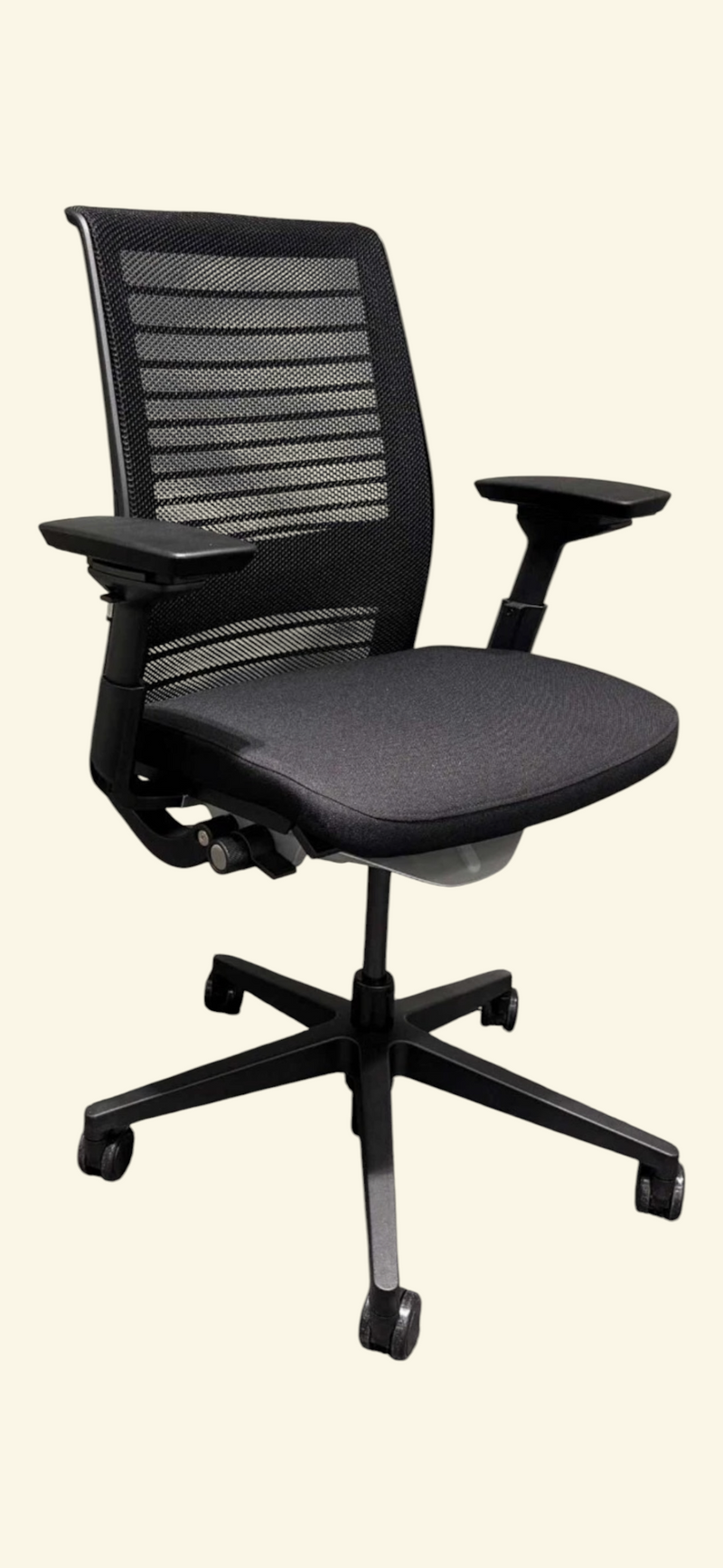 Steelcase Think V2 black mesh ergonomic office chair – front three-quarter view showing the fabric seat, 4D arms and castor base